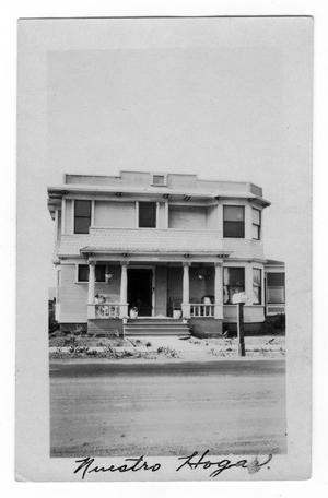 Primary view of object titled 'A House with the Caption Nuestro Hogar'.