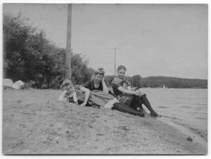 Primary view of object titled '[Photograph of Women Sitting Along a Shore]'.