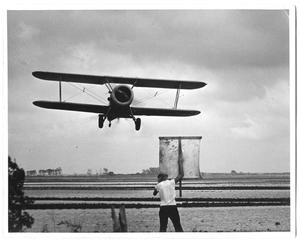 Primary view of object titled '[Airplane Seeding a Field]'.