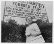 Photograph: [Woman by Cemetery Sign]