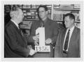 Photograph: [Three Men Holding Number "1"]