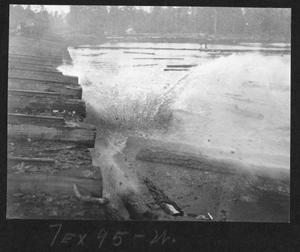 Primary view of object titled '[Log falling into the Southern Pine Lumber Company Mill Pond]'.