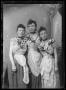 Photograph: [Three young women adorned with flowers]