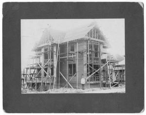 Primary view of object titled '[Men constructing house]'.