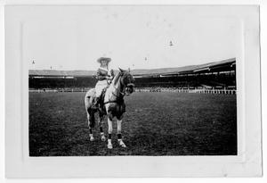 Primary view of object titled '[Ruth Roach astride a horse in an arena in Paris, France]'.