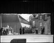 Thumbnail image of item number 1 in: '[Actors performing in front of a cityscape drama set]'.