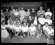 Photograph: [League of bowlers pose in front of bowling lanes]