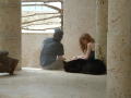 Thumbnail image of item number 1 in: '[Young couple sit inside a stone structure, near a window]'.
