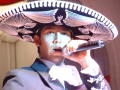 Photograph: [Close-up of man in sombrero with microphone]