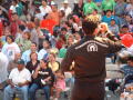 Primary view of [Photo from behind man with microphone facing crowd]
