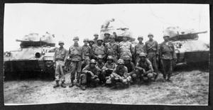 Primary view of object titled '[Soldiers pose in front of military tank]'.