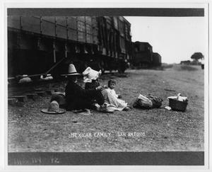 Primary view of object titled '[Photograph of a family next to train tracks]'.