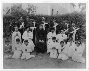 Primary view of object titled '[Catechism school graduates with priest]'.