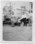 Photograph: [Rudy Vara, Cindy Vara-Leija, and two men standing by a poultry truck]