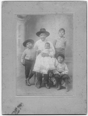 Primary view of object titled '[Family photograph of a man holding a baby and three boys]'.