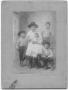 Photograph: [Family photograph of a man holding a baby and three boys]