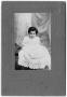 Photograph: [Photograph of a young child dressed in white]