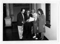 Photograph: [Tom Kreneck and group looking at documents]
