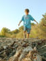 Photograph: [Boy walks on a pile of wood]