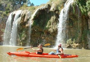 Primary view of object titled '[Two women kayaking near a waterfall]'.