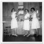 Photograph: [Three Women in Front of Drawers]
