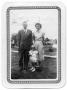 Photograph: [Parents and Their Daughter Standing on a Lawn]