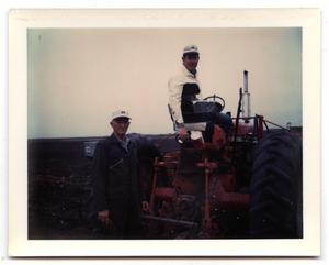 Primary view of object titled '[Carl and Curtis Jensen Working with a Tractor on Their Farm]'.
