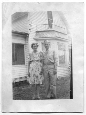 Primary view of object titled '[Agnes and Melvin Hansen in Front of Family Home]'.