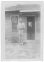 Photograph: [Melvin Hansen in Front of Brick House]