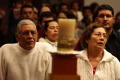 Photograph: [Congregation of a Catholic Church is shown at worship]