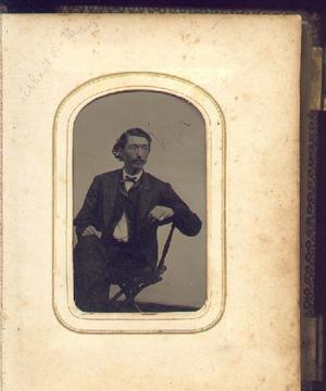 Primary view of object titled '[Albert Nolan Herbert sitting in a chair]'.