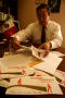 Photograph: [Oscar Solis Flores handling papers on his desk]