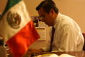 Photograph: [Oscar Solis Flores with Mexican flag in foreground]
