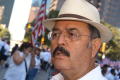 Photograph: [Hector Flores with crowd and American flag in background]