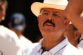 Photograph: [Hector Flores in casual shirt and straw hat]