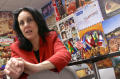Primary view of [Ann Marie Weiss with posters and small flags in the background]