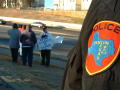 Thumbnail image of item number 1 in: '[Police officer in foreground and group of protesters in background]'.