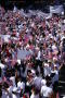 Primary view of [Crowd of Immigration Protesters Wave Signs and American Flags, April 9, 2006]