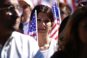 Primary view of object titled '[Woman protester holds an American flag]'.