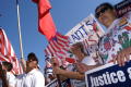 Photograph: [Immigration Protesters Hold American Flags and Signs]