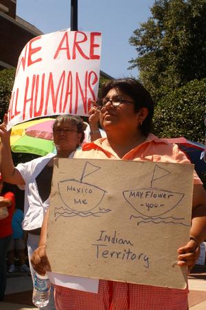 Primary view of object titled '[Two women holding protest signs, "We are all humans," and "Mexico me, Mayflower you"]'.