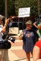 Primary view of [Protester with anti-immigration sign, "Let's use Mexico's immigration law"]
