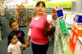 [Isabel Segovia, and her children are seen at a pharmacy in Grand Prairie, Texas]