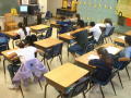 Primary view of [Empty desks reveal the number of absent students in a classroom]