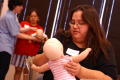 Photograph: [Mothers use dolls to help in first aid training]