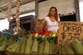 Primary view of [Woman placing cardboard sign into group of vegetables]