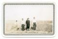 [Photograph of a Boy, two Men, and a Woman]