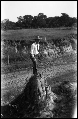 Primary view of object titled '[Photograph of a Man Standing on a Rock]'.