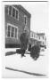 Photograph: [Mr. Ellis in front of the telephone building]