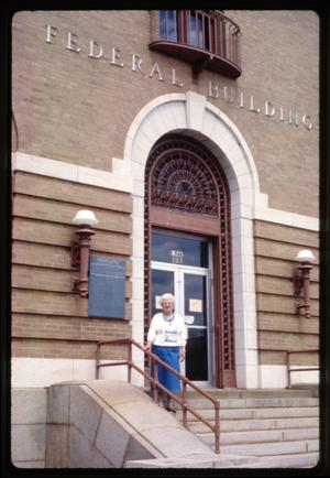 Primary view of object titled '[Unidentified Woman on Steps of Federal Building]'.